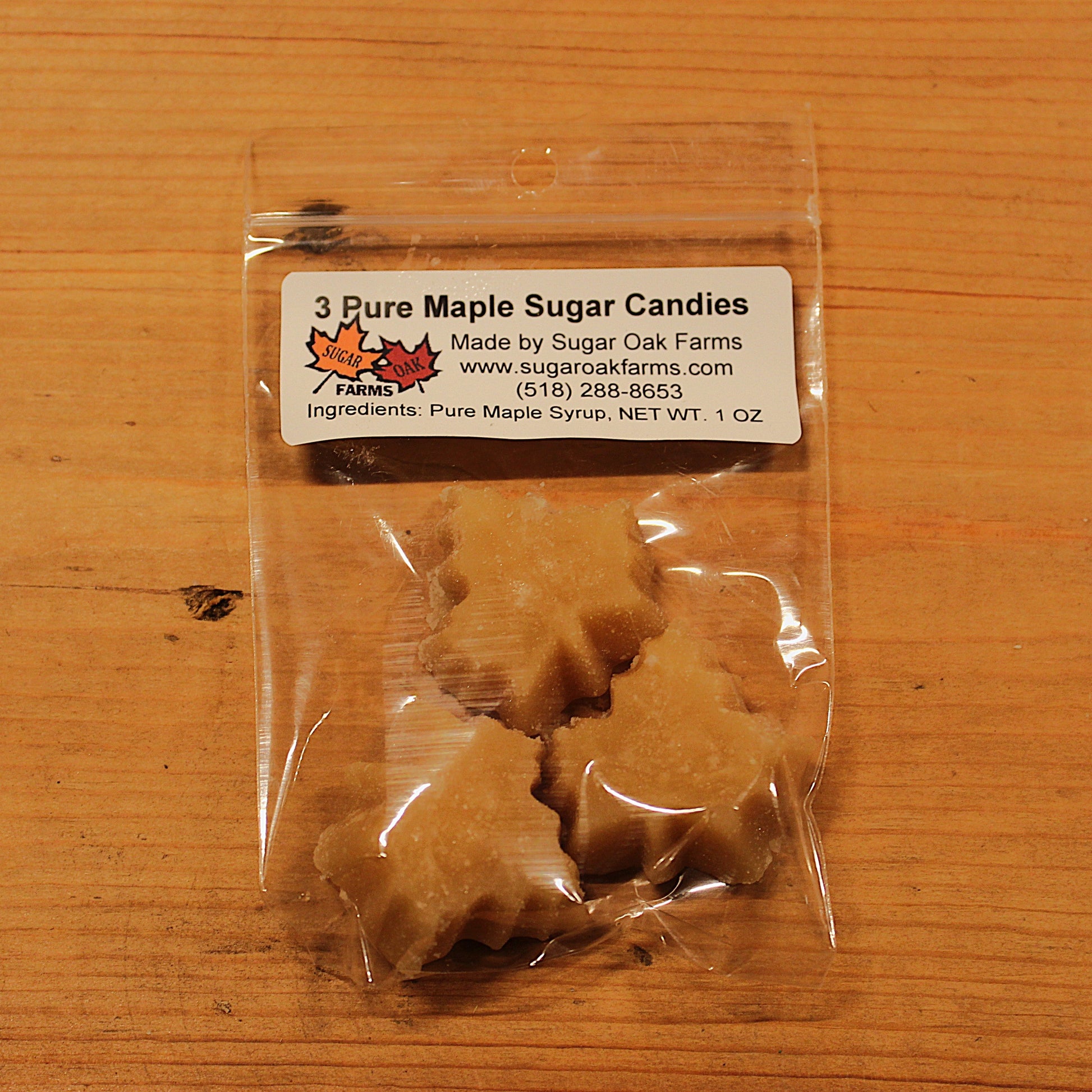 Clear package of pure maple sugar candies with a label on a wooden surface